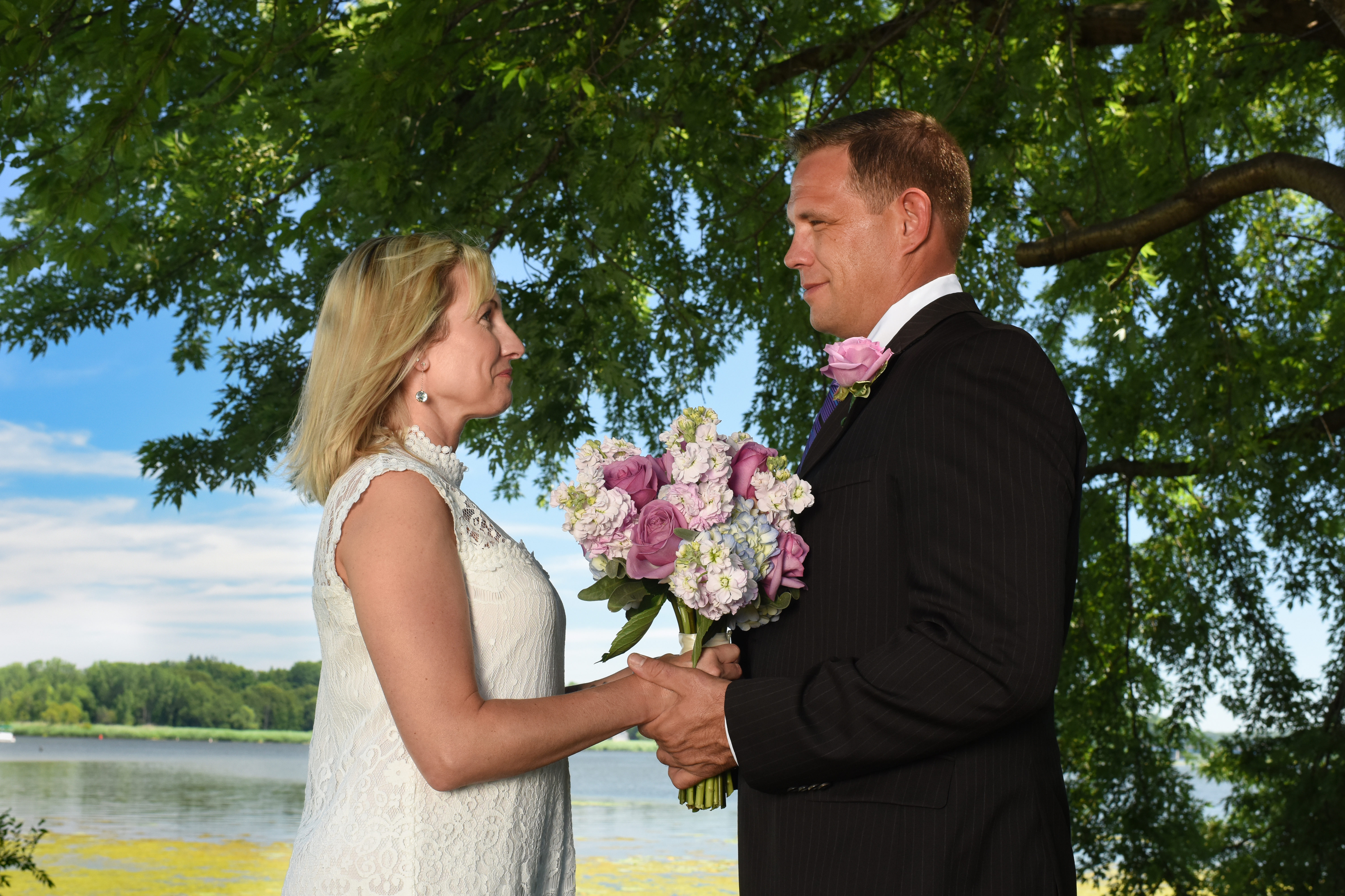close up of couple during wedding with water in background at wade's bayou