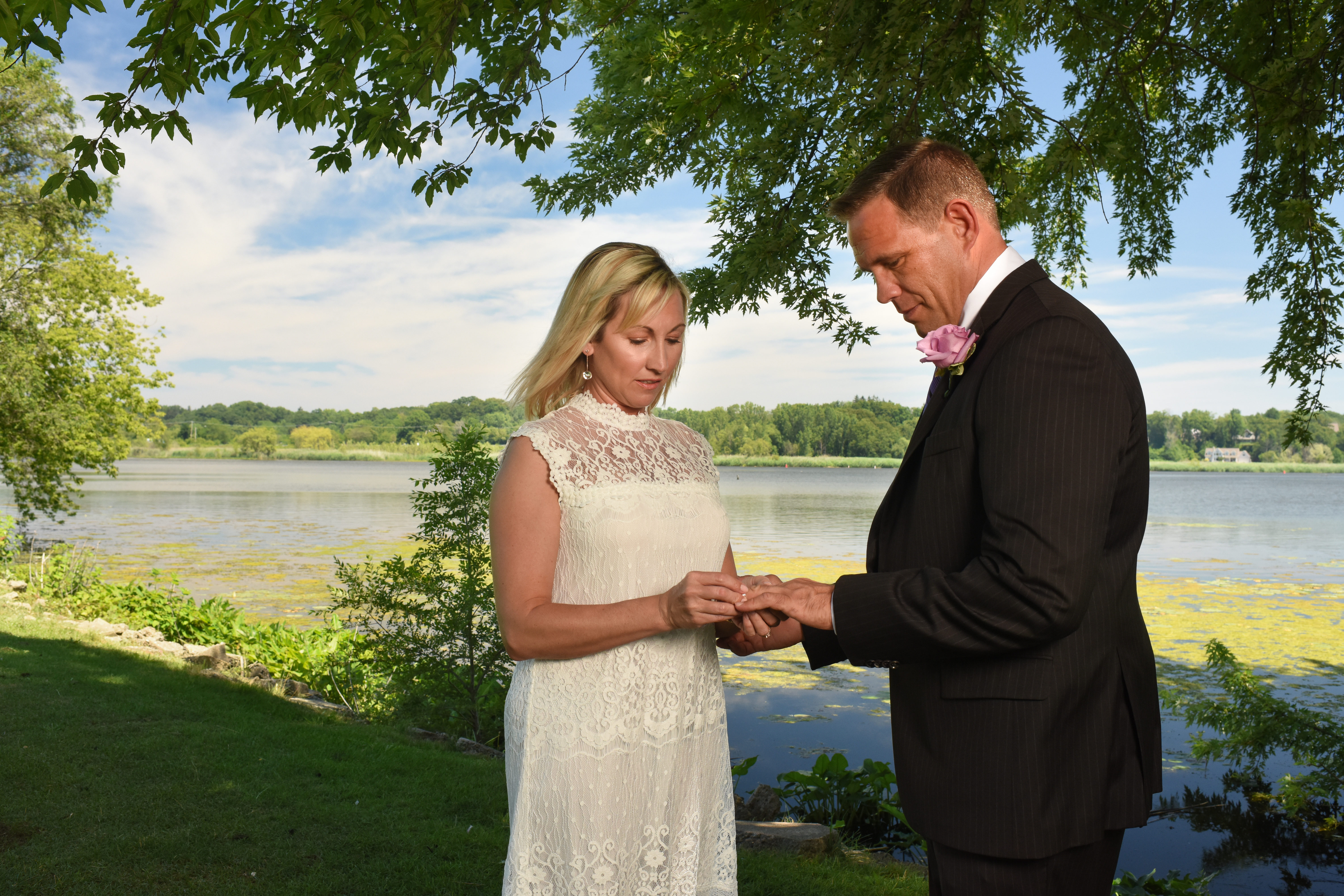 Couple exchanging wedding rings during thier wade's bayou elopement