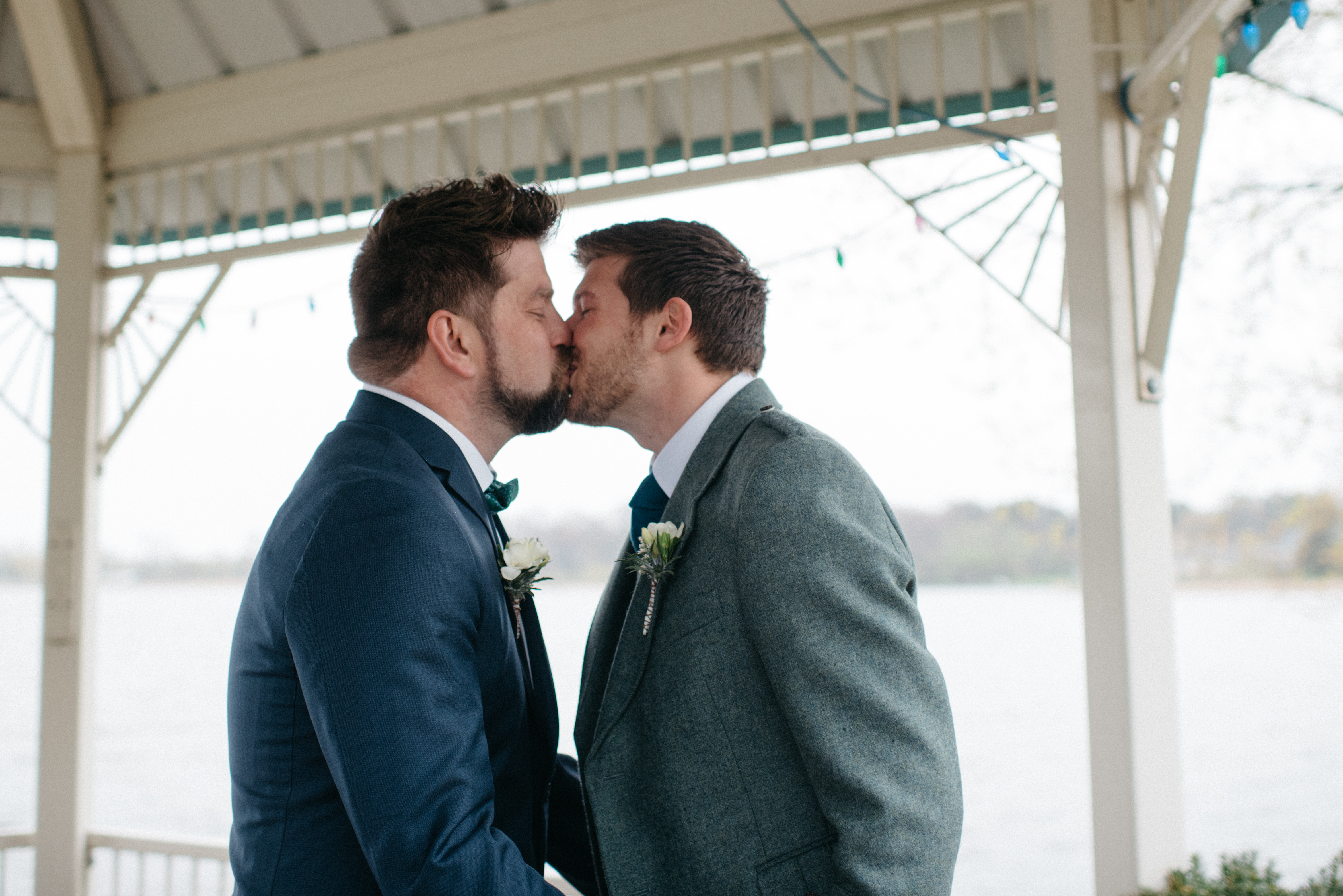 men share thier first married kiss at wade's bayou memorial park