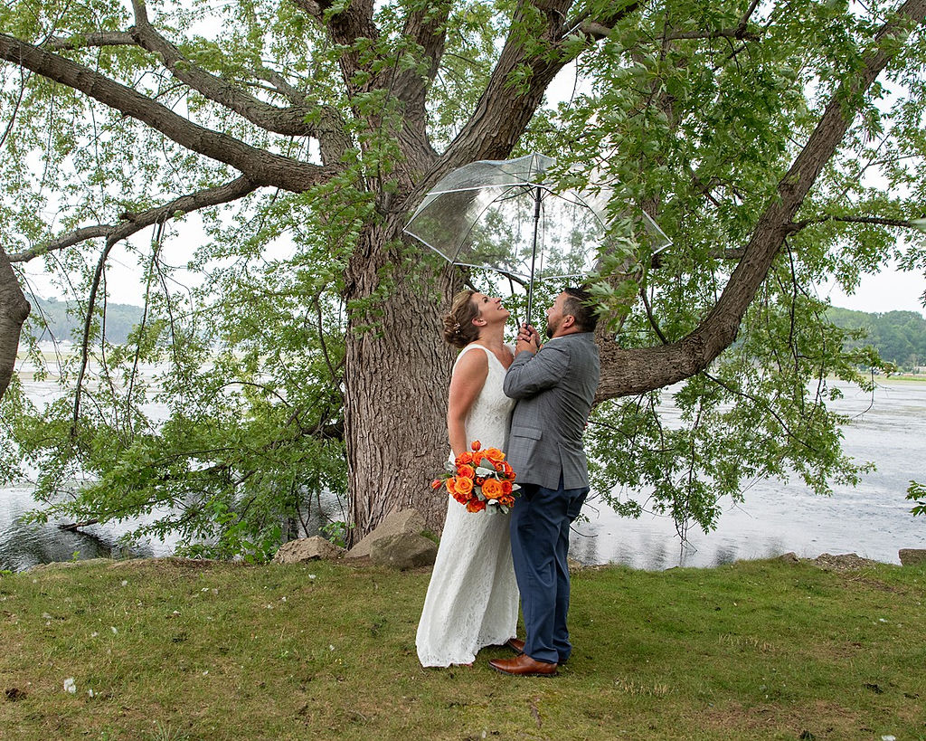 A couple under a tree at Wade's Bayou at their simple weddding