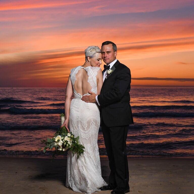 photography of bride and groom on beachw ith sunset